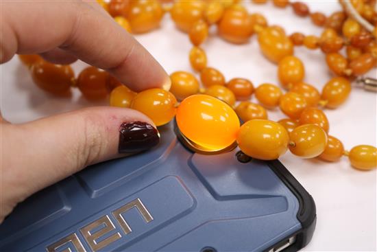 Three assorted single strand graduated amber bead necklaces.